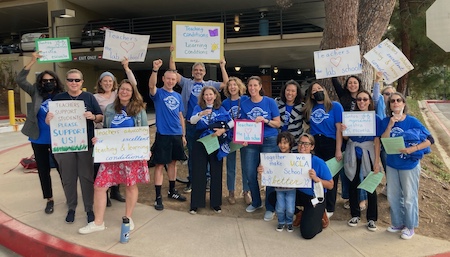UC Lab School workers and supporters rally with signs of support